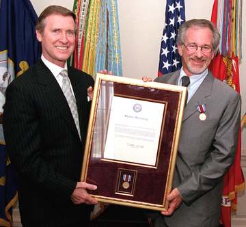 Secretary of Defense William S. Cohen, (left) presents a framed citation accompanying the en:Department of Defense Medal