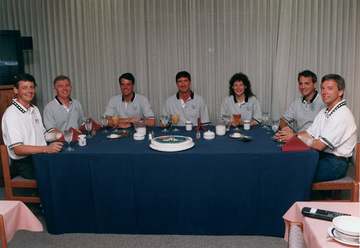 Enjoying breakfast in the Operations and Checkout Building are the seven crew members assigned to Space Shuttle Mission 