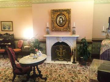 Parlor with furniture, fireplace, and painting of Ida Saxton McKinley First Ladies National Historic Site Keywords: Firs