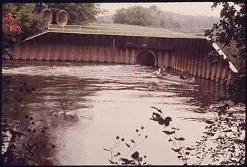 Canoeists pass the discharge point for the Akron, Ohio water treatment plant on the Cuyahoga River